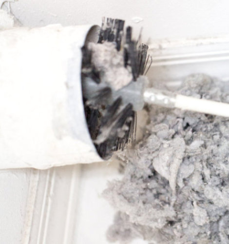 Dryer vent cleaning brush and removed lint
